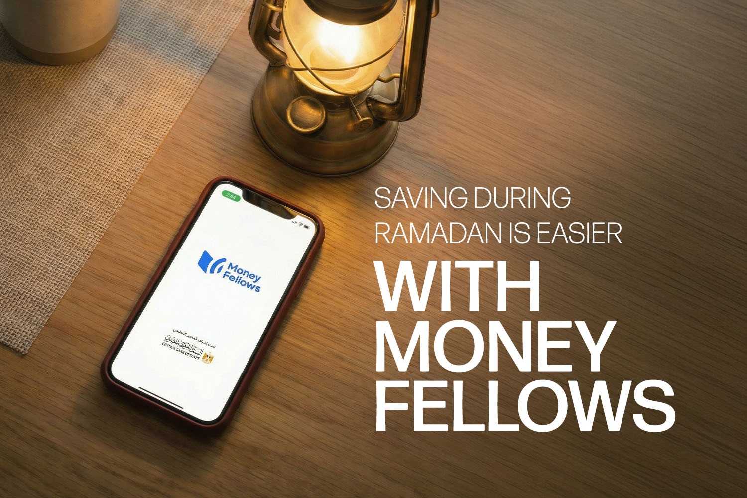 A smart phone with money fellows app logo and the CBE logo on its screen. besides it a traditional Ramadan lantern from Ramadan Budget Guide article.